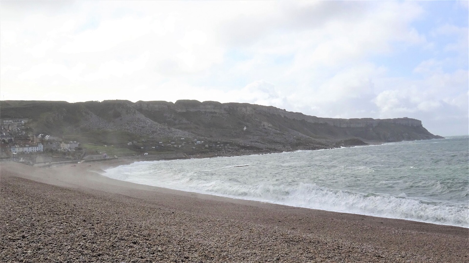 Chesil Beach curving away from Portland with the cliffs of West Weares