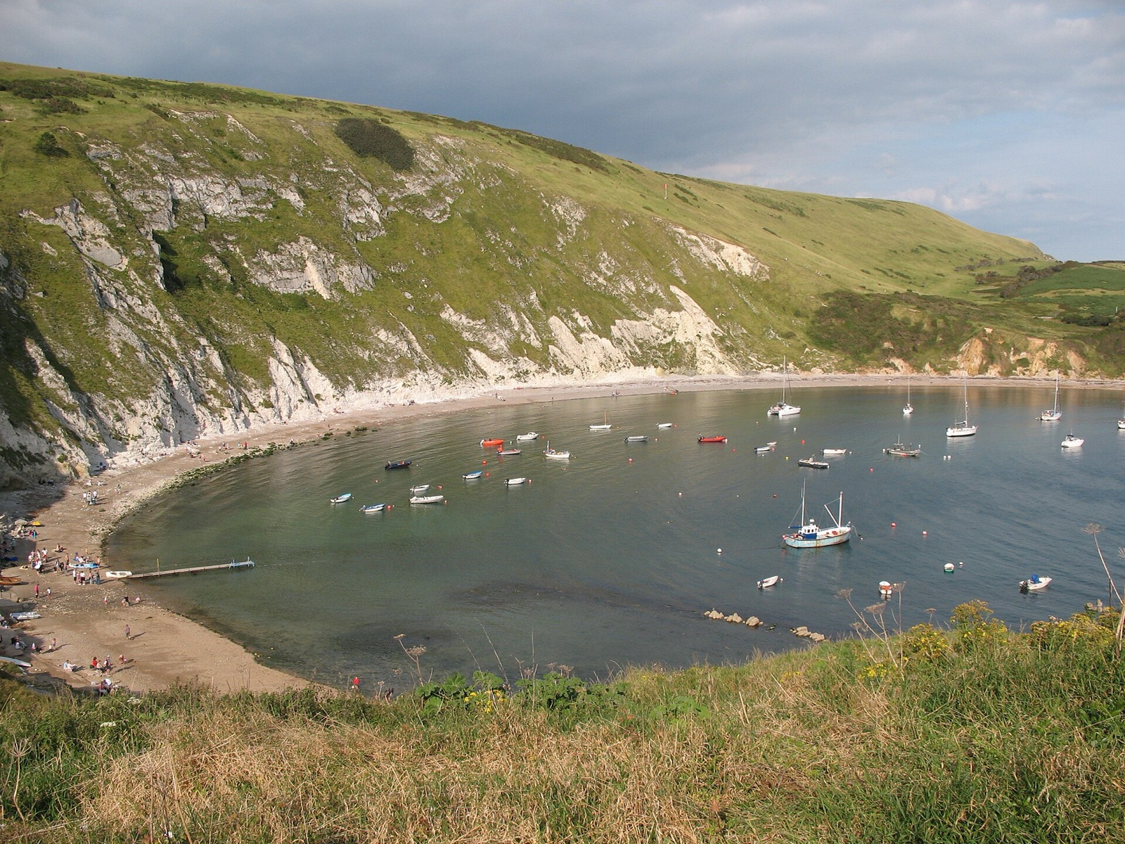 Lulworth Cove, an almost circular bay with boats at anchor