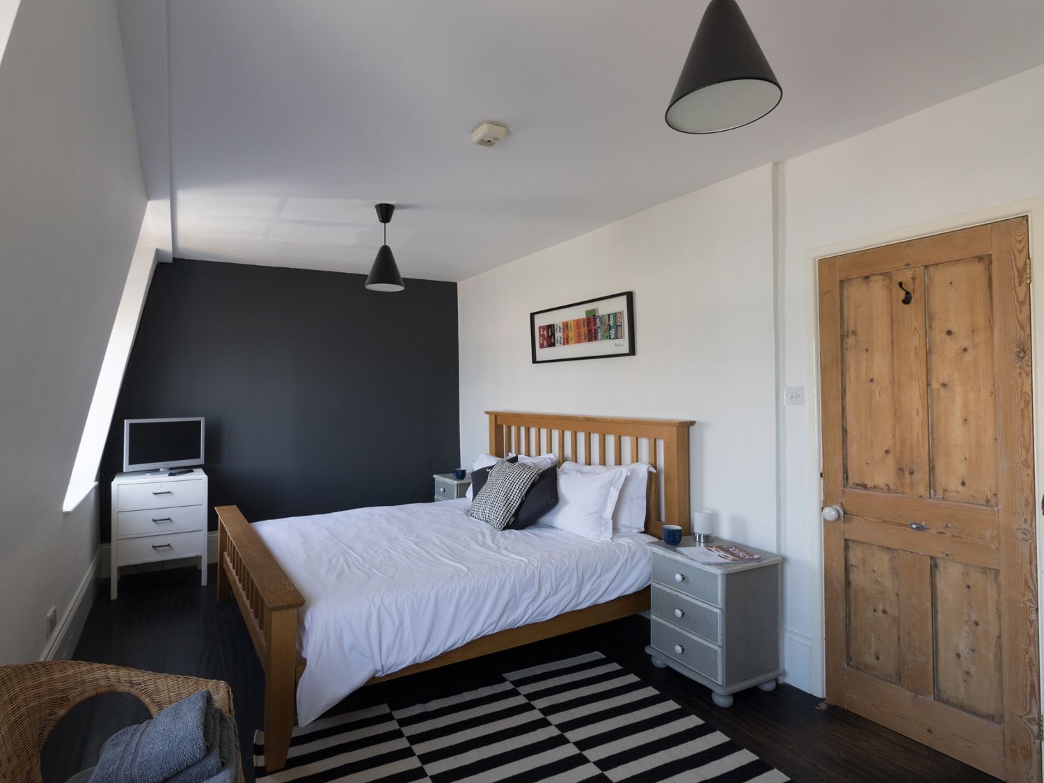 King-size bedroom at Sailor's Watch with a dark feature wall